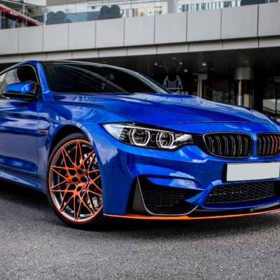 blue-sport-sedan-parked-yard blue-sport-sedan-parked-yard
